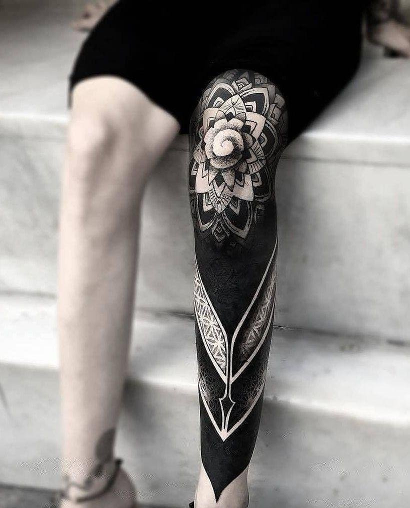 Blackwork tattoo on the leg for women