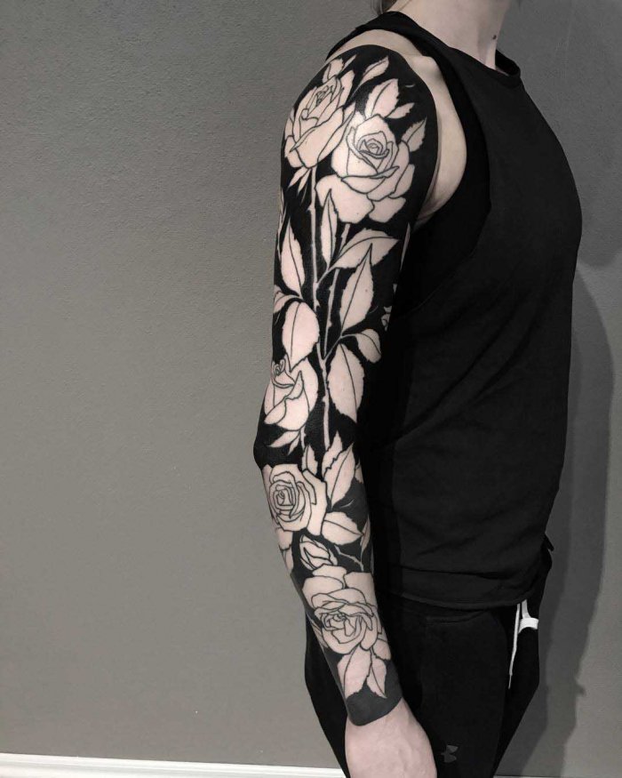 Large blackwork style flower tattoo on the arm for men