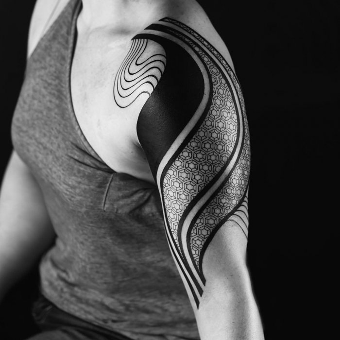 Blackwork style tattoo on the shoulder for men