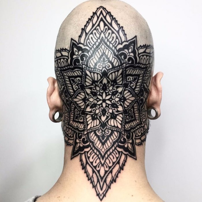 Tattoo on the back of the head in the style of blackwork for men