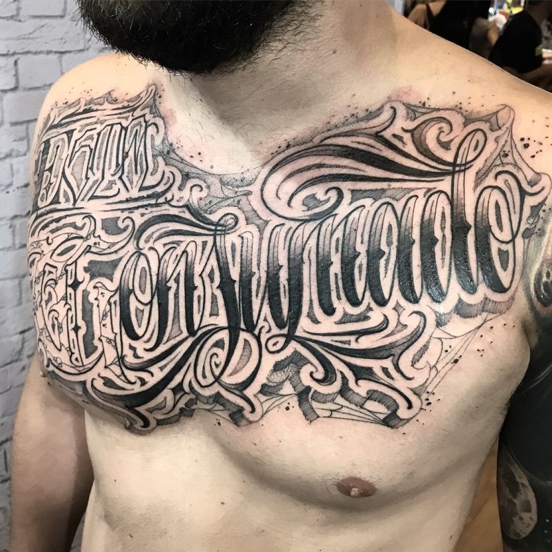 Calligraphy chest tattoo for men