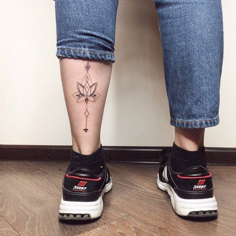 Lotus tattoo on the calf for women