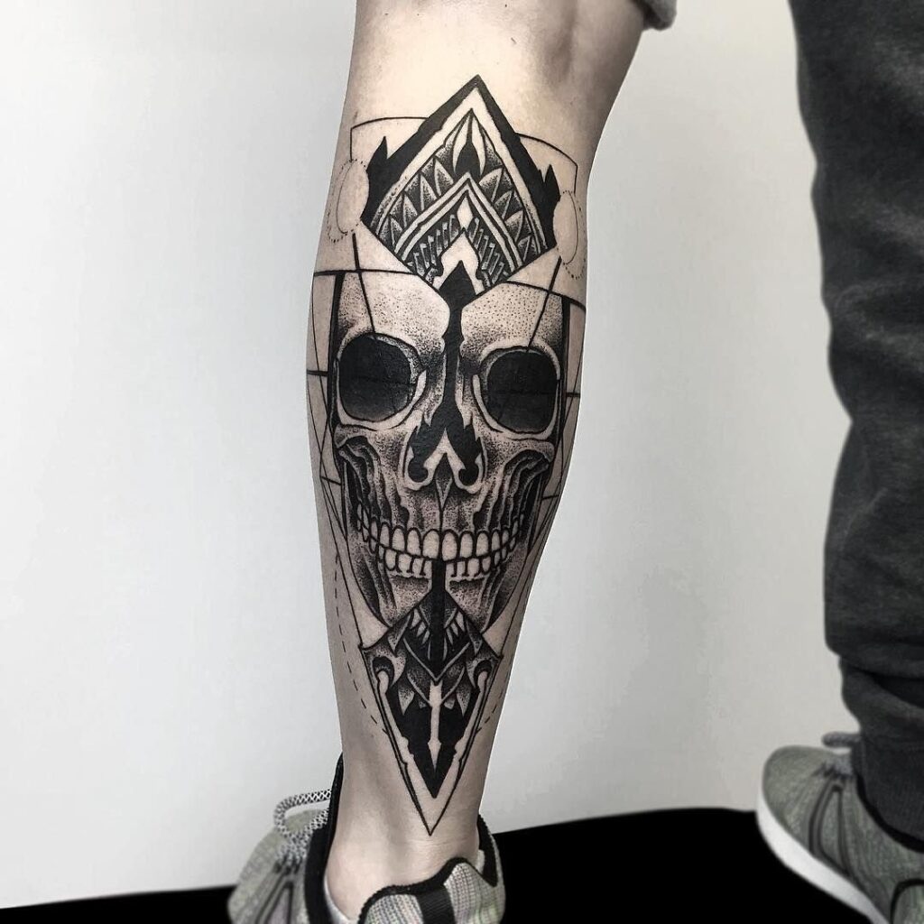 Large skull tattoo on the calf for men