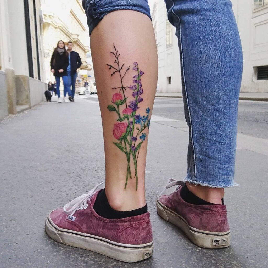 Large flower tattoo on the calf for women