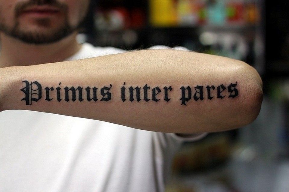 Tattoo with an inscription on the arm for men