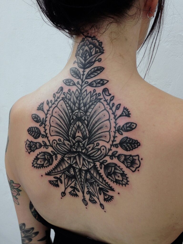 Flower tattoo on the back for women