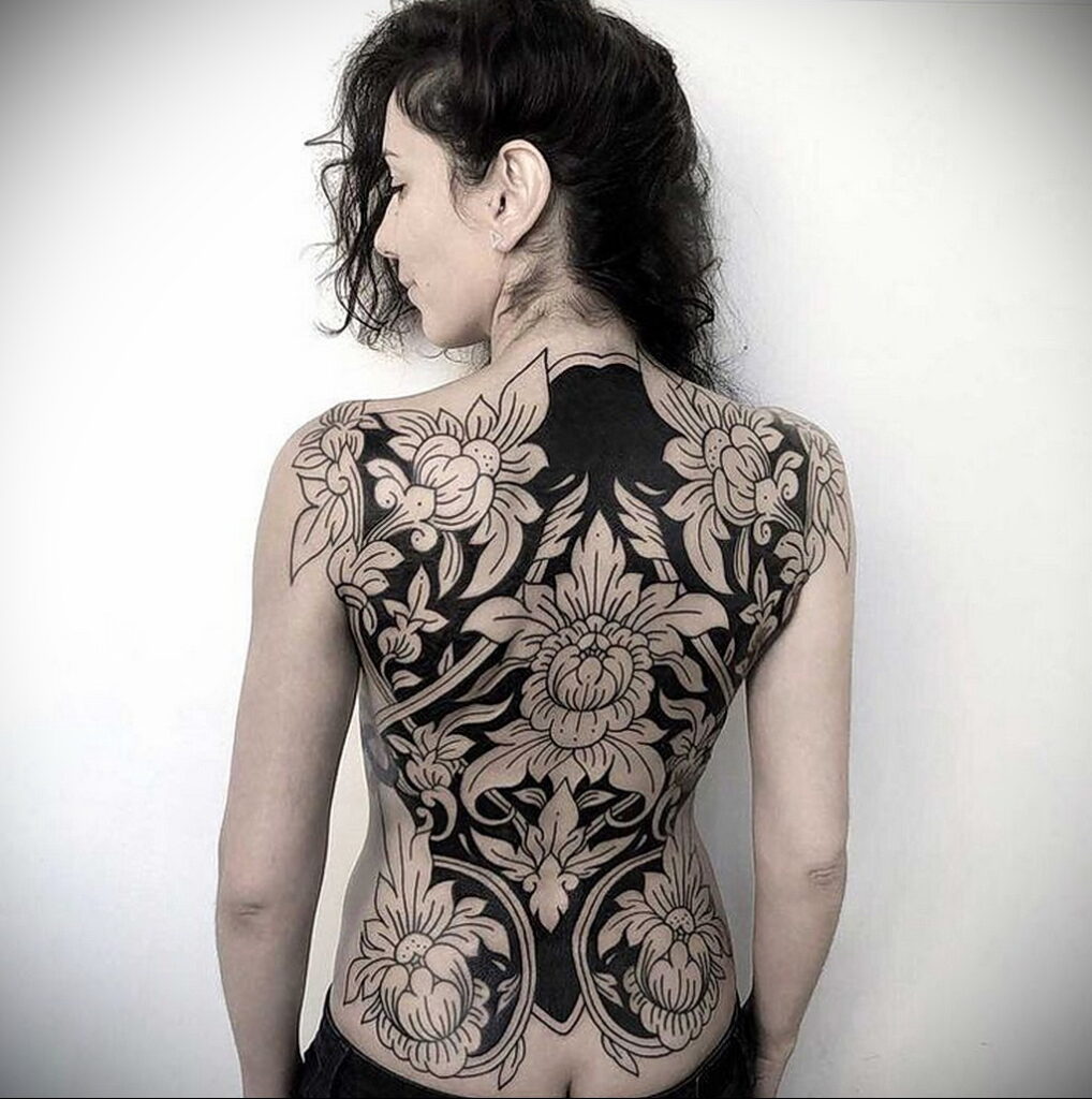 Large flower tattoo on the back for women