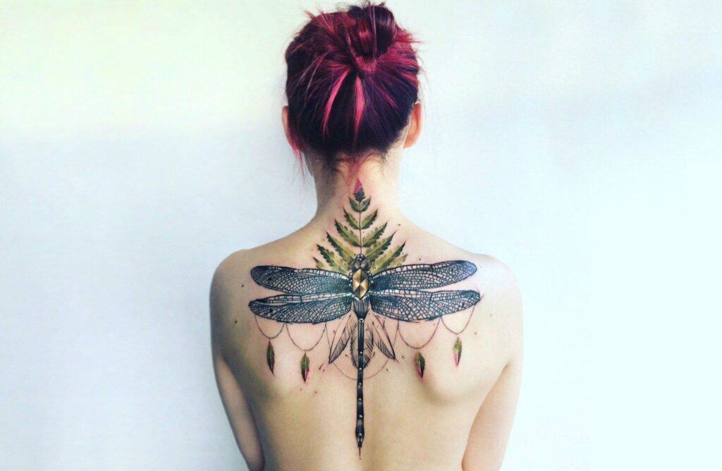 Large dragonfly tattoo on the back for women