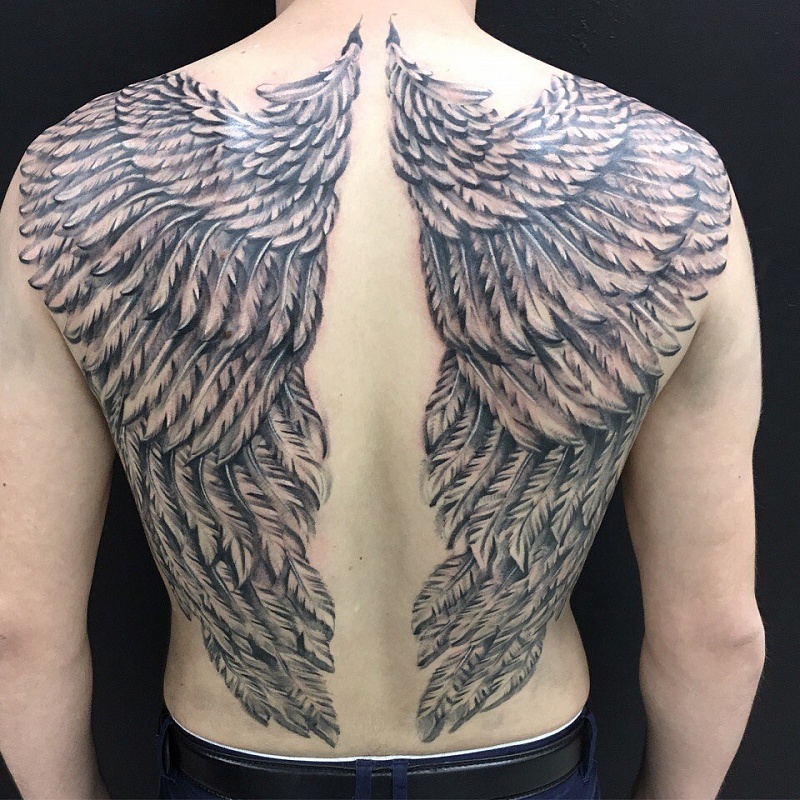 Large tattoo of wings on the back for men