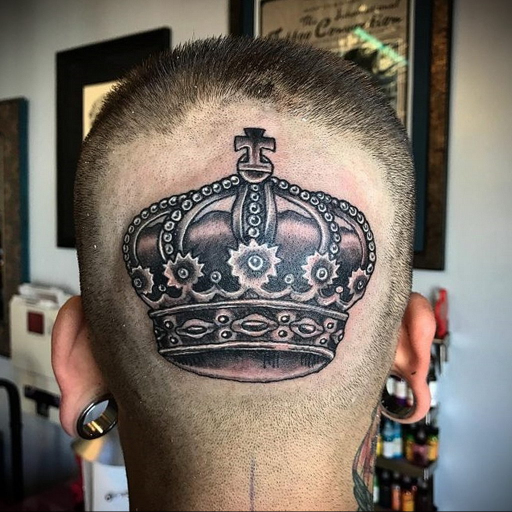 Large crown tattoo on the back of the head for men