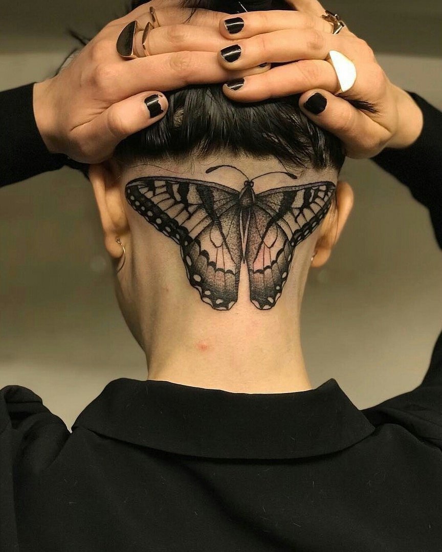 Large butterfly tattoo on the back of the head for women