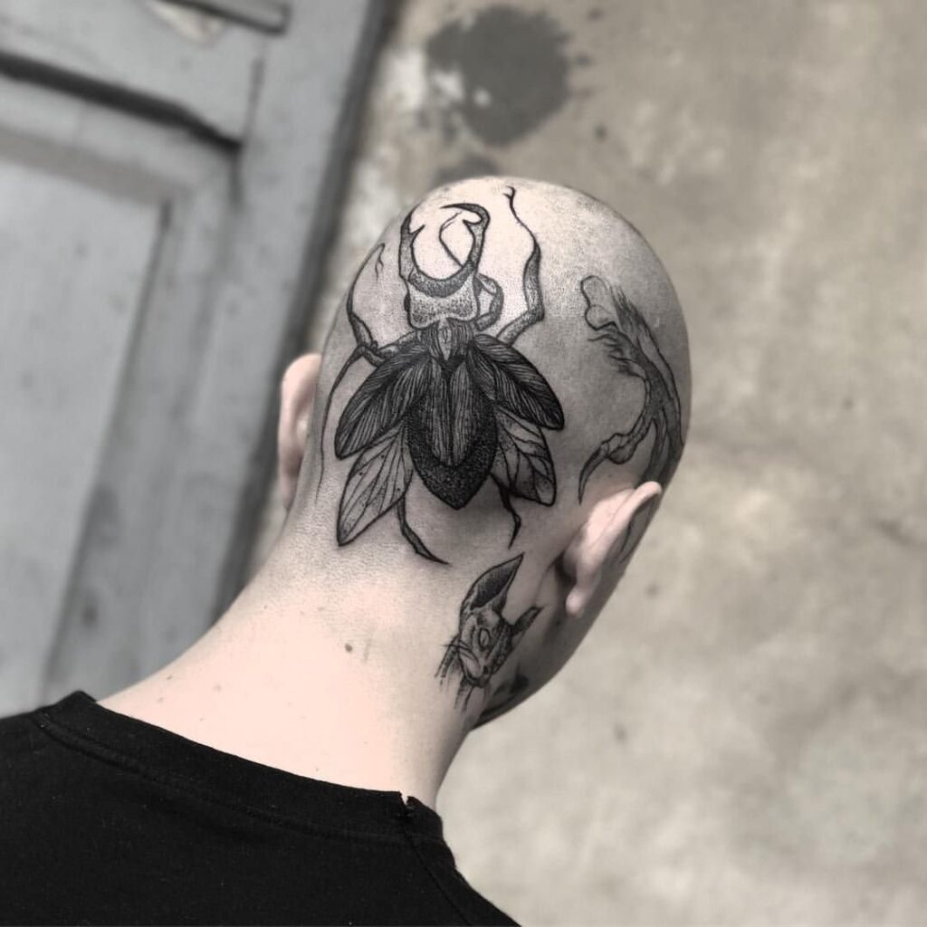 Large bug tattoo on the back of the head for men