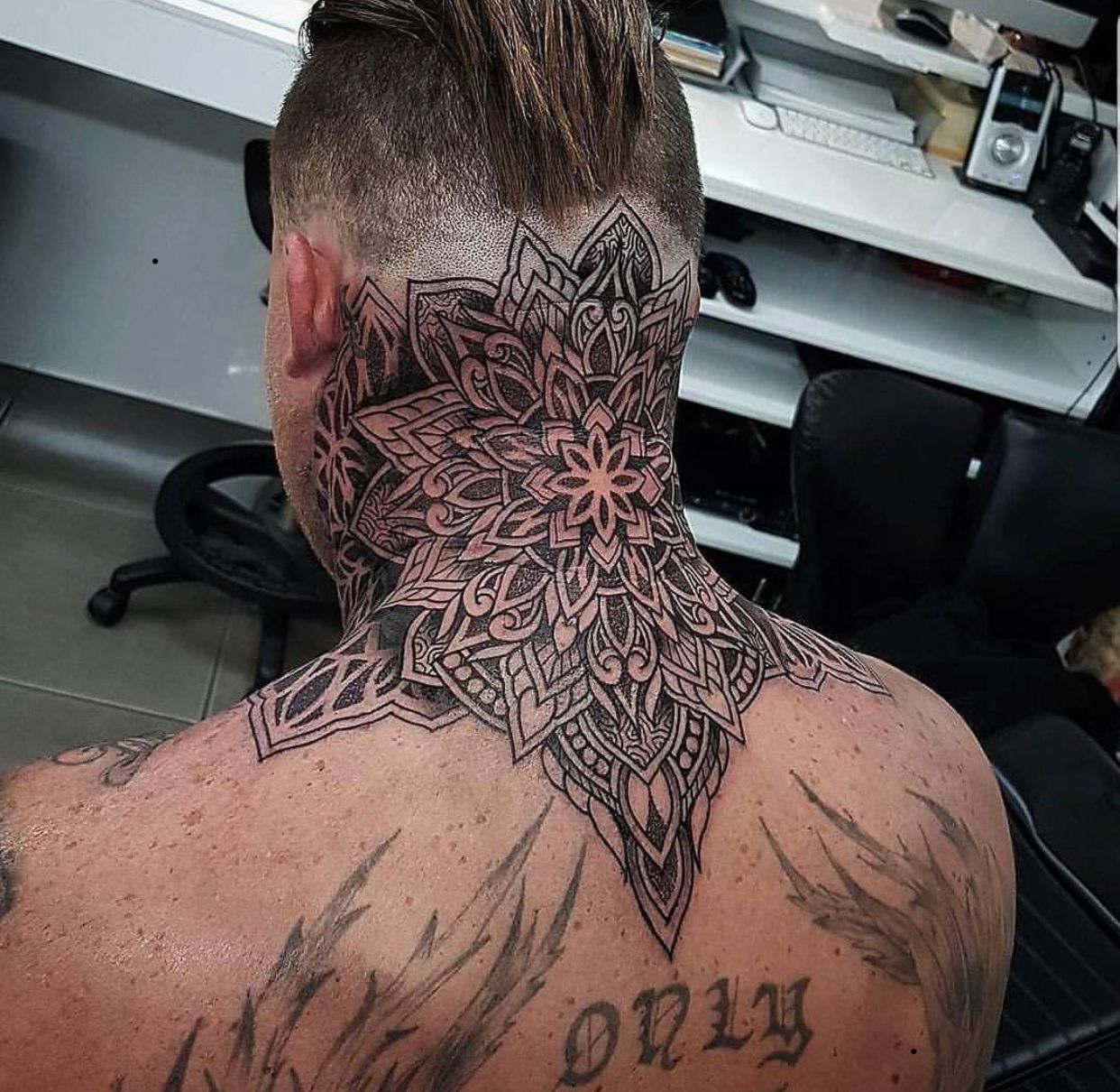 Large tattoo on the back of the head for men