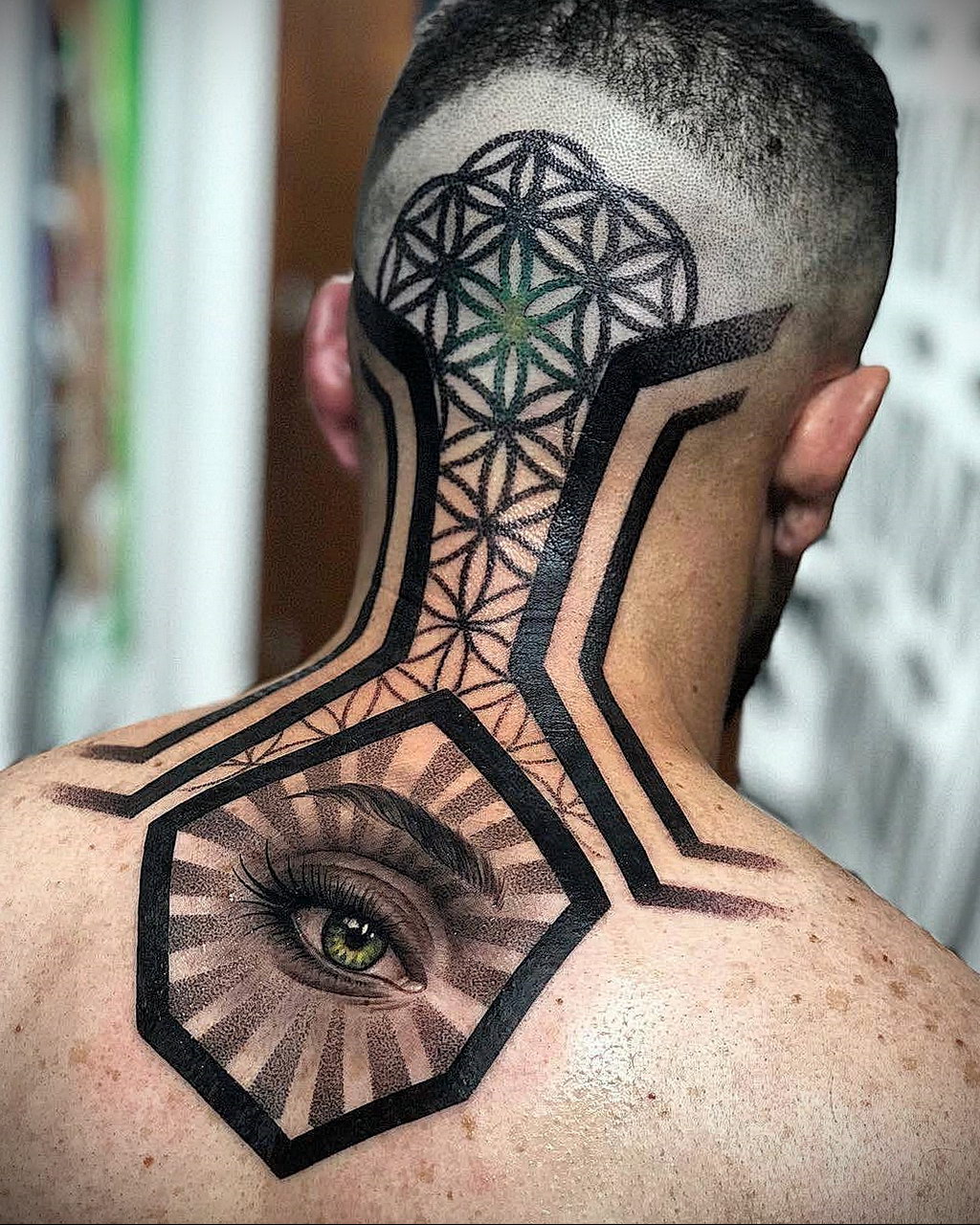 Large tattoo on the back of the head for men