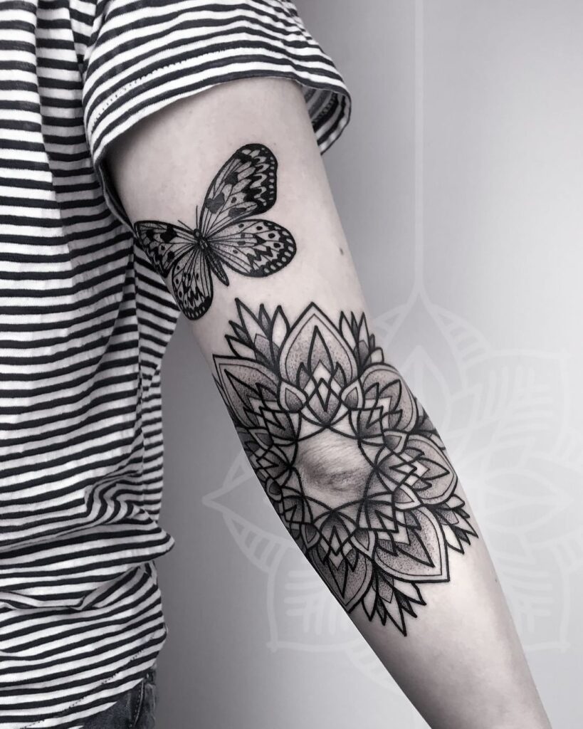 Mandala tattoo on the elbow for women