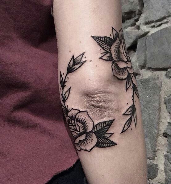 Tattoo of two roses on the elbow for men