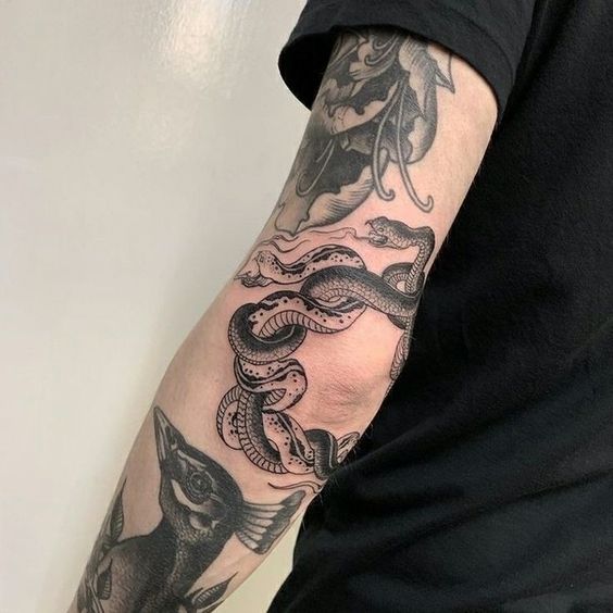 Snake tattoo on the elbow for men