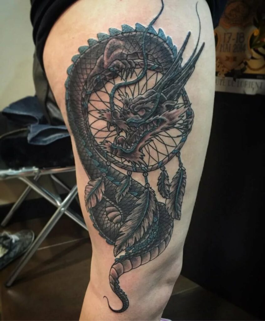 Large dragon tattoo on the thigh for women