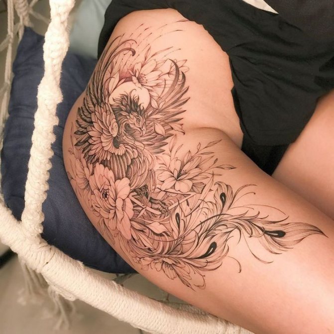 Tattoo of a phoenix on the thigh for women