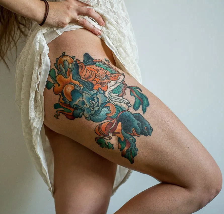 Colorful fox tattoo on the hip for women