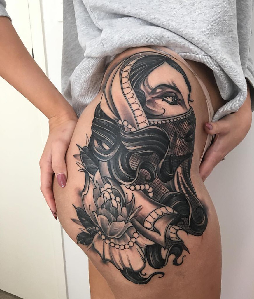 Big girl tattoo on the thigh for women