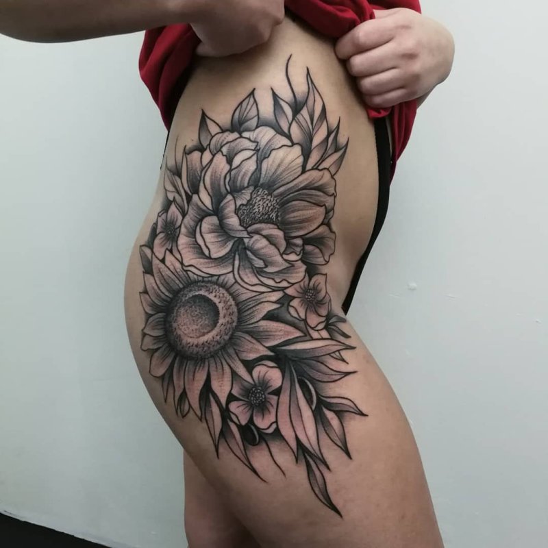 Large flower tattoo on the thigh for women