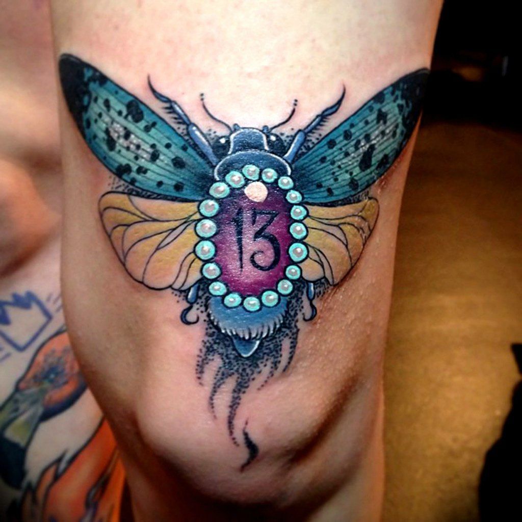 Big butterfly tattoo on the knee for men