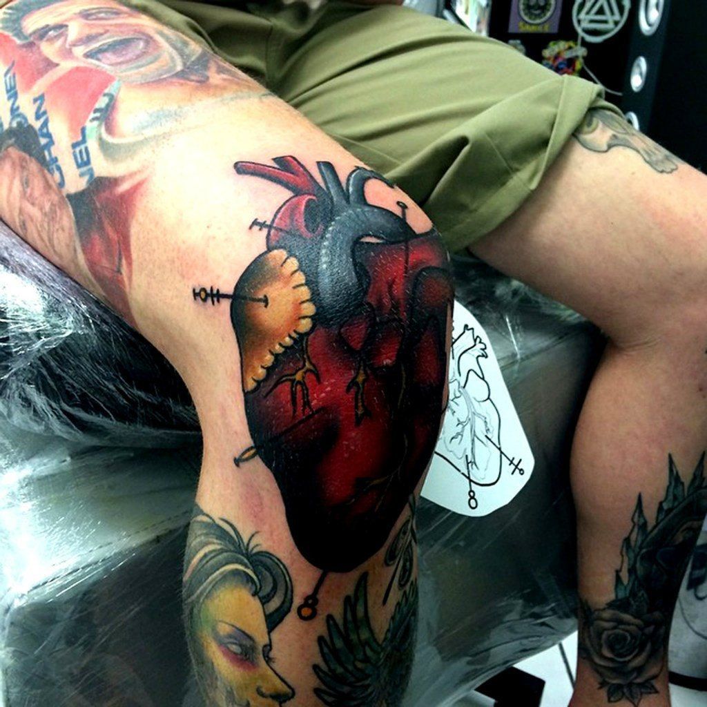 Large heart tattoo on the knee for men