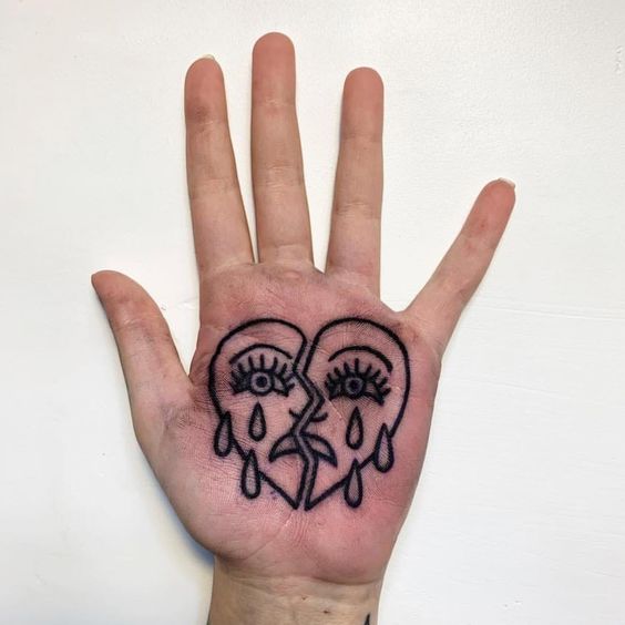 Heart tattoo on the palm of the hand for women