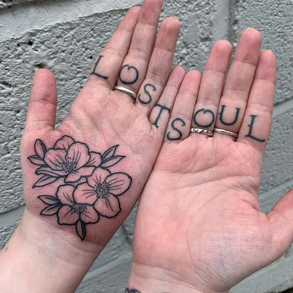 Flower tattoo on the palm of the hand for women