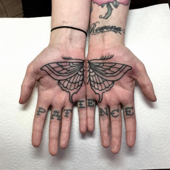 Butterfly tattoo on the palm of the hand for women