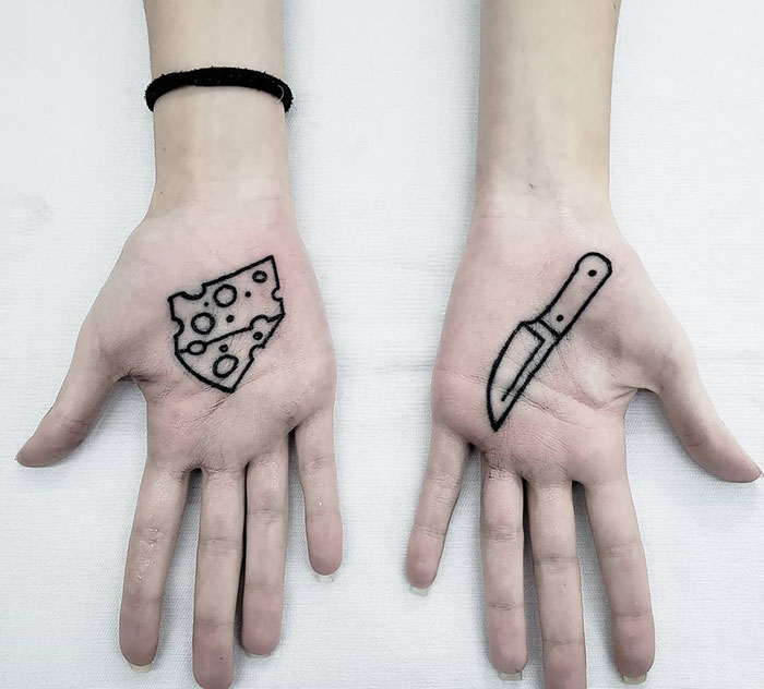 Cheese and knife tattoo on the palm of the hand for women