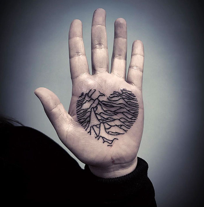 Heart tattoo on the palm of the hand for women