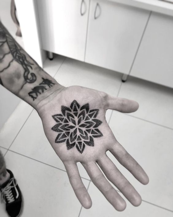 Flower tattoo on the palm of the hand for men