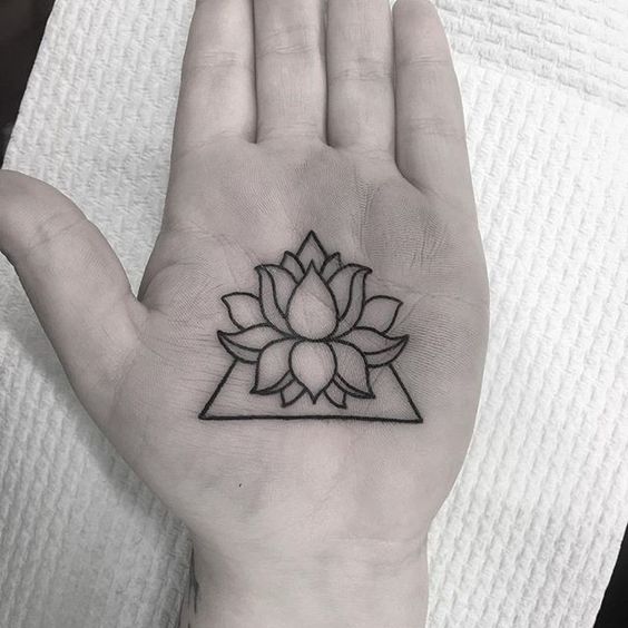 Lotus tattoo on the palm of the hand for women