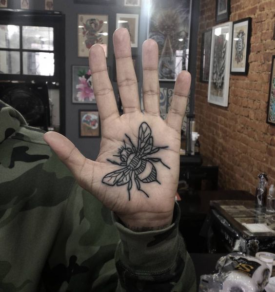 Tattoo of a wasp on the palm for men