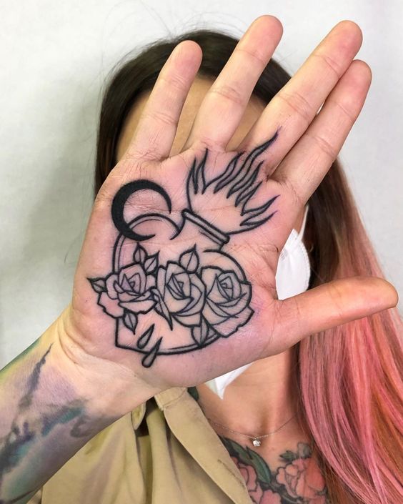 Tattoo of roses and moon on the palm of the hand for women