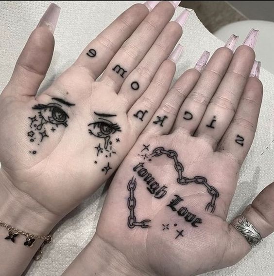 Eye and chain tattoo on the palm of the hand for women