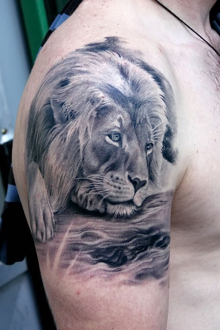 Large lion tattoo on the shoulder for men