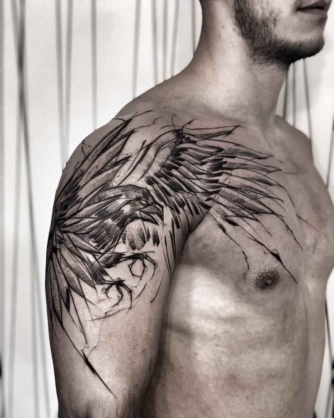 Tattoo of a raven on the shoulder for men