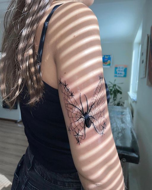 Spider tattoo on the shoulder for women