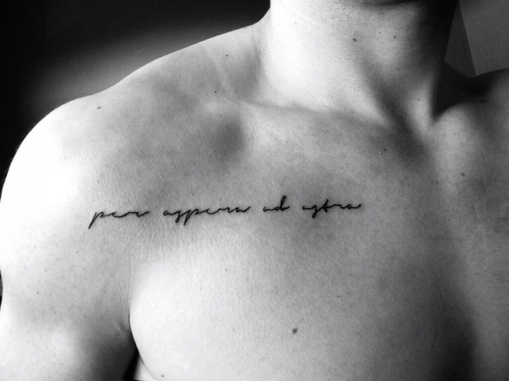 Tattoo with an inscription on the shoulder for a man