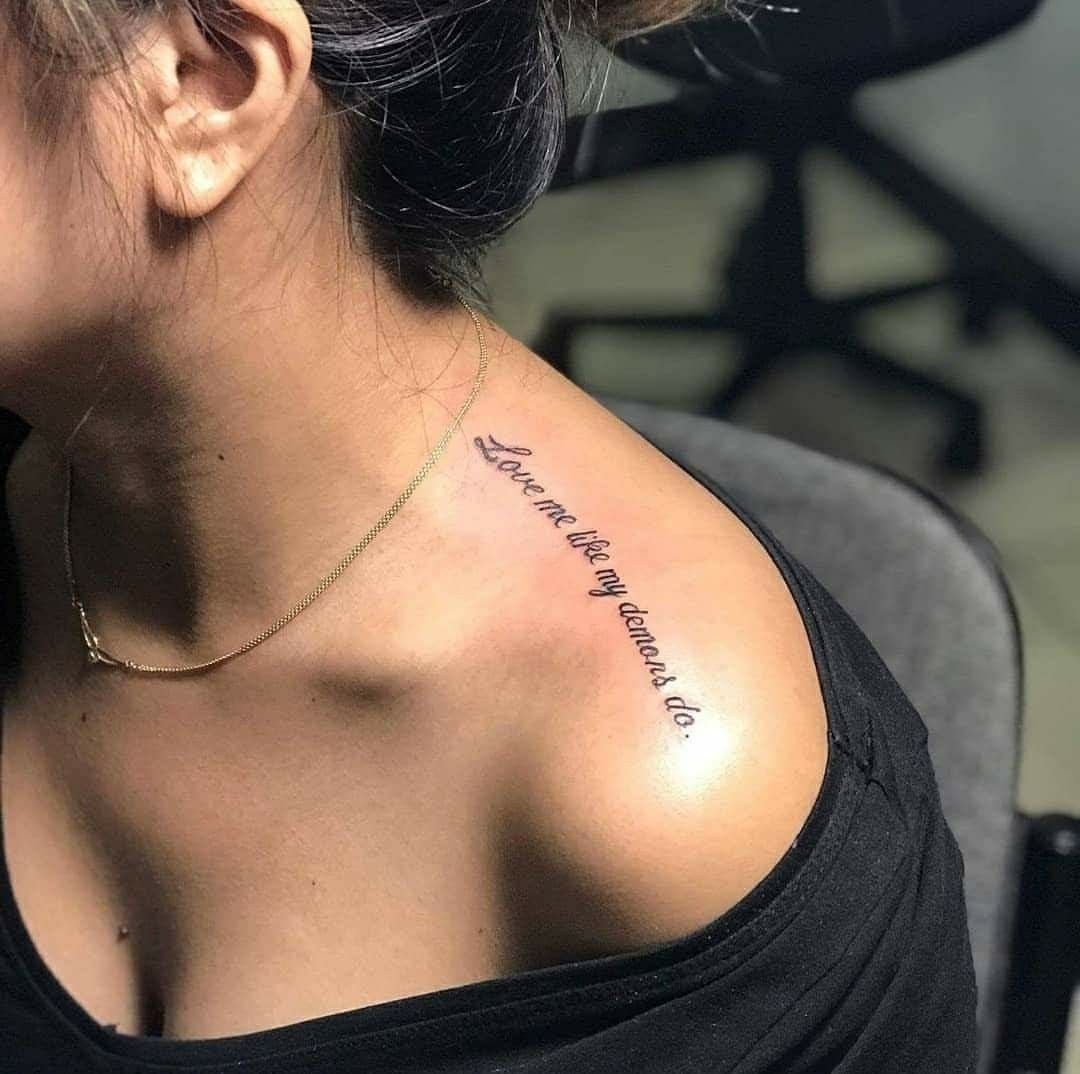 Tattoo with an inscription on the shoulder for women