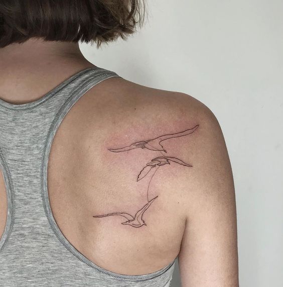 Bird tattoo on the shoulder blade for women