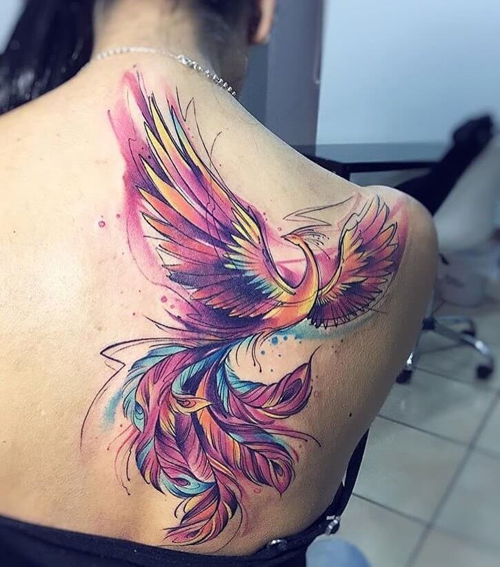 Colorful tattoo of a firebird on the scapula for women