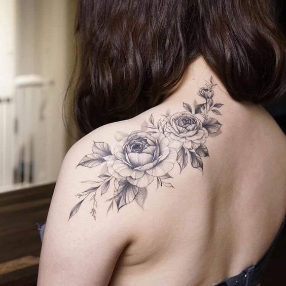 Tattoo of two roses on the shoulder blade for women