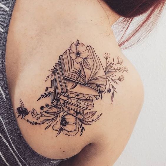 Large book tattoo on the shoulder blade for women