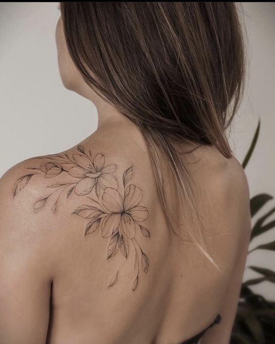 Flower tattoo on the shoulder blade for women