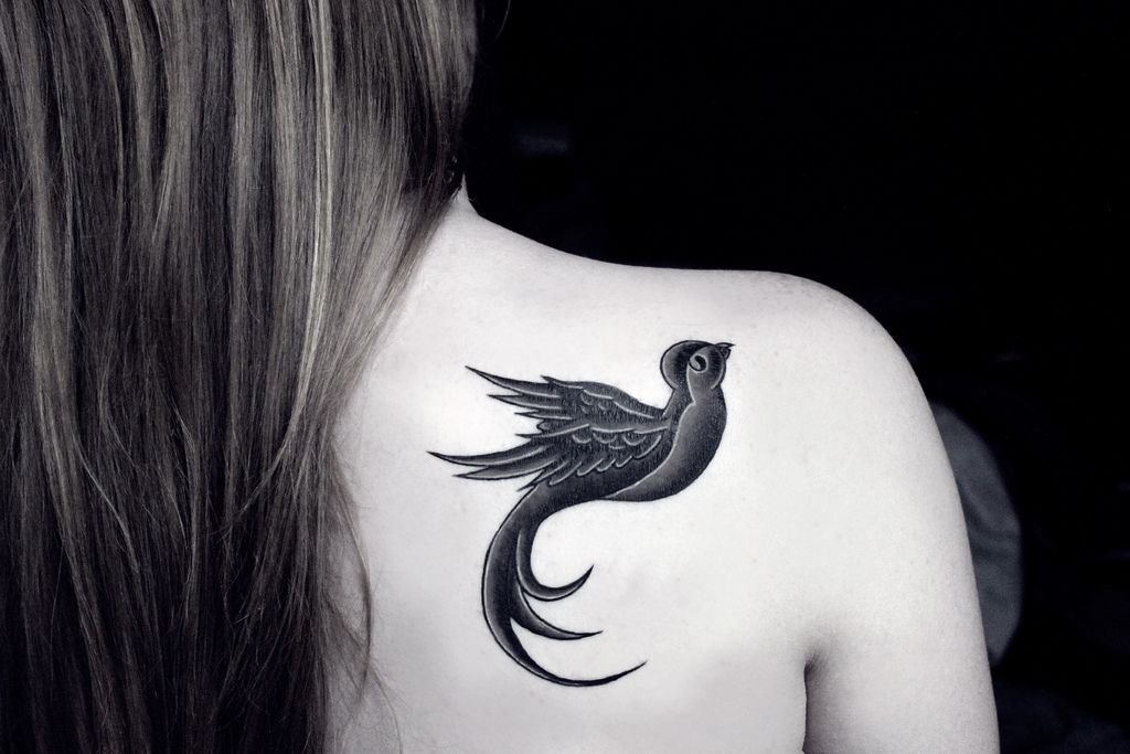 Bird tattoo on the shoulder blade for women