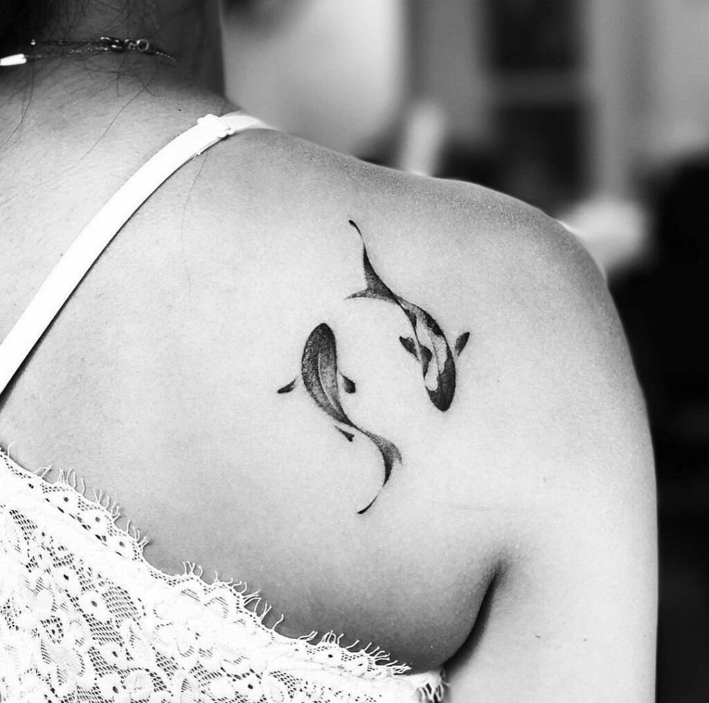 Koi fish tattoo on the shoulder blade for women